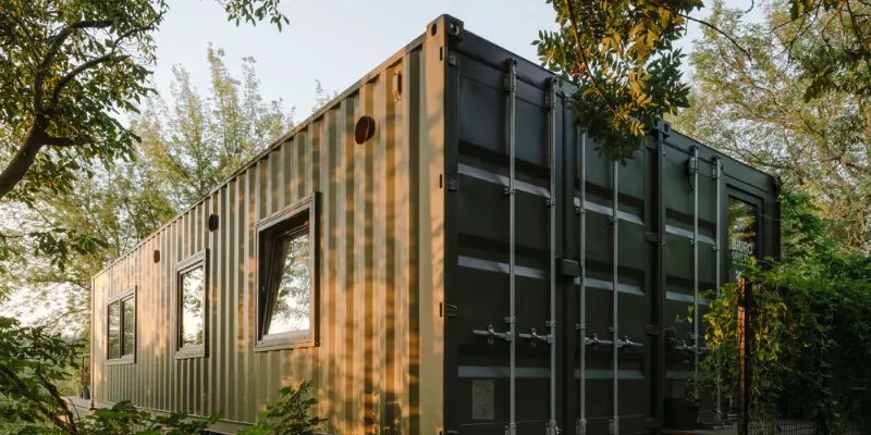 used shipping container home surrounded with greenary